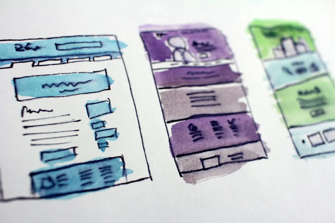 Website layouts sketched in watercolour