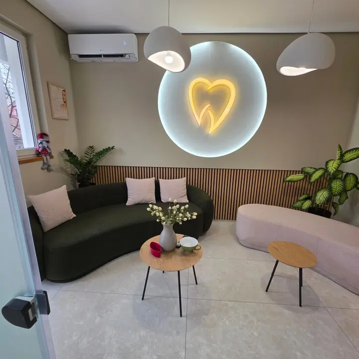 The lounge at Dr. Sremčević’s practice in Kraljevo, with the practice’s glowing tooth logo