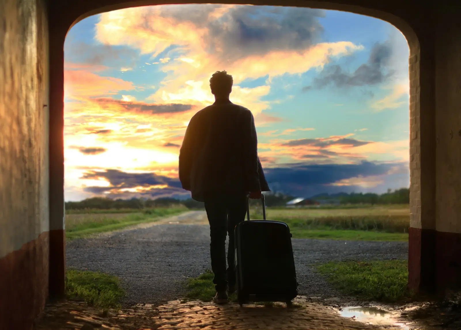 Traveller with luggage at sunset