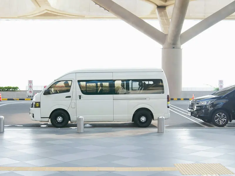 A van waiting at an airport terminal